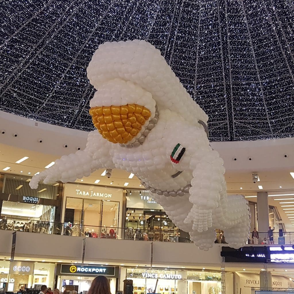 Large-scale spaceman balloon sculpture installed at Dubai Marina Mall — Stages of Air — Out of Thin Air